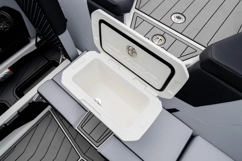 Slide: The Image of 2026 Nautique Super Air Nautique GS22 interior with open storage compartment. - 26