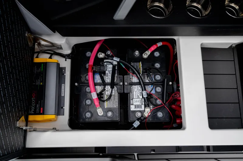 Slide: The Image of 2026 Nautique Super Air Nautique GS22 battery compartment with ProSport HD12 charger. - 32