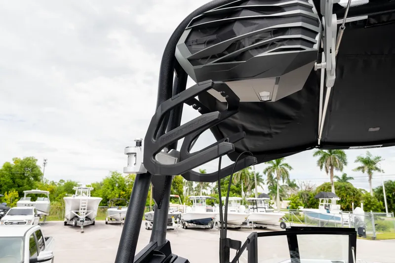 Slide: The Image of 2026 Nautique Super Air Nautique GS22 boat tower with speaker, docked with other boats. - 37