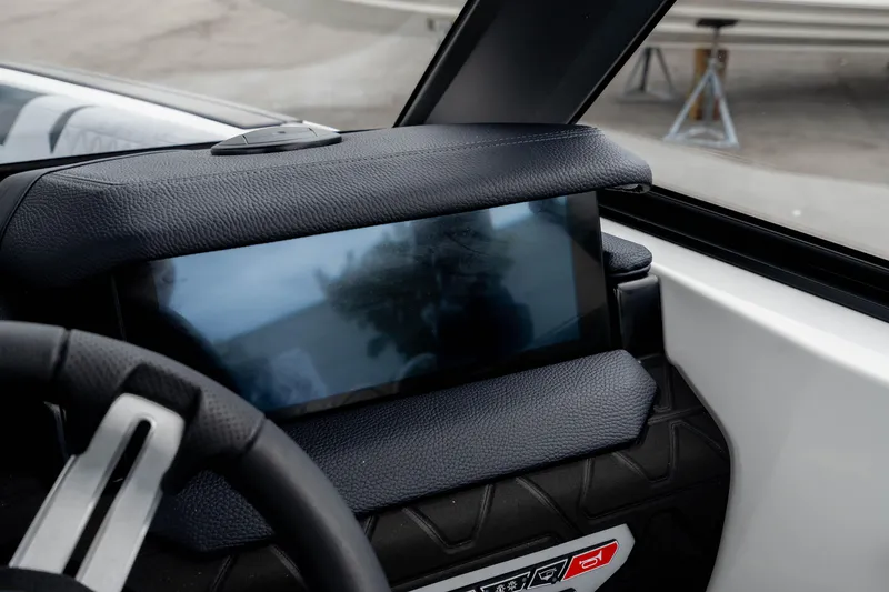 Slide: The Image of 2026 Nautique Super Air Nautique GS22 dashboard with touchscreen display and steering wheel detail. - 42