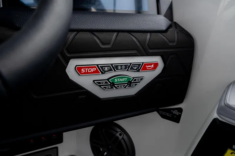 Slide: The Image of 2026 Nautique Super Air Nautique GS22 dashboard controls with start and stop buttons. - 43