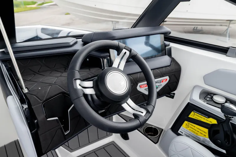 Slide: The Image of 2026 Nautique Super Air Nautique GS22 steering wheel and dashboard interior view. - 7