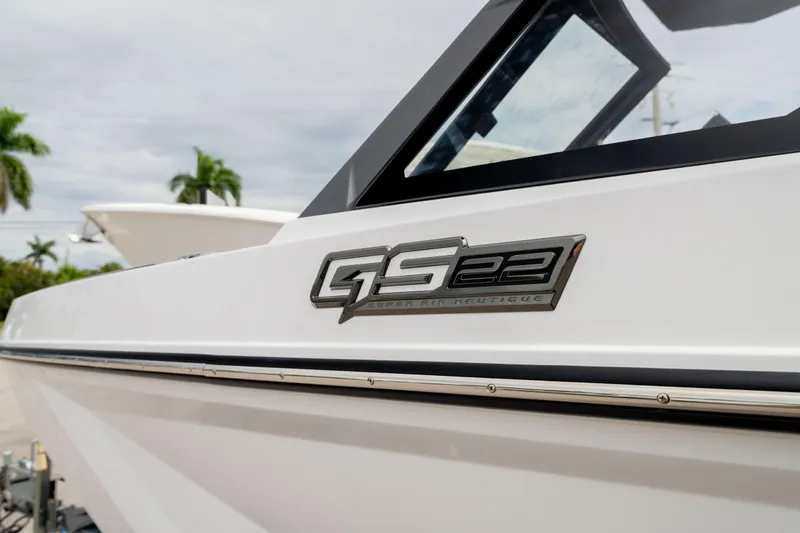 Slide: The Image of 2026 Nautique Super Air Nautique GS22 boat, side view with logo detail. - 8