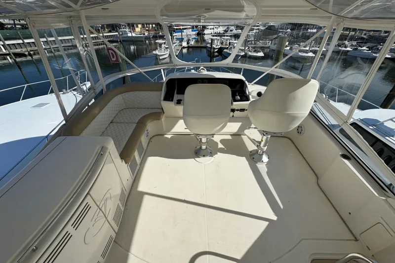 Slide: The Image of Flybridge of 2009 Ovation 52 yacht with helm chairs and marina view. - 11