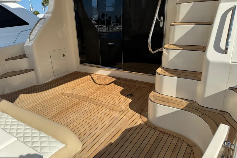 Slide: The Image of Luxurious 2009 Ovation 52 yacht deck with wooden flooring and elegant stairs. - 13