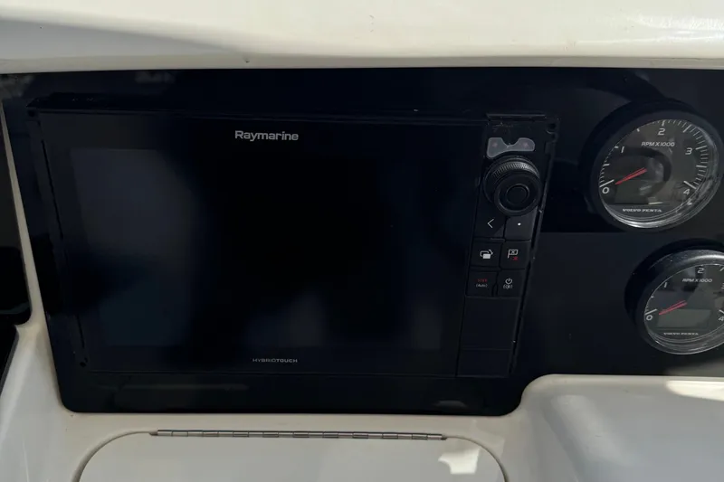 Slide: The Image of Raymarine display and gauges on 2009 Ovation 52 boat dashboard. - 18