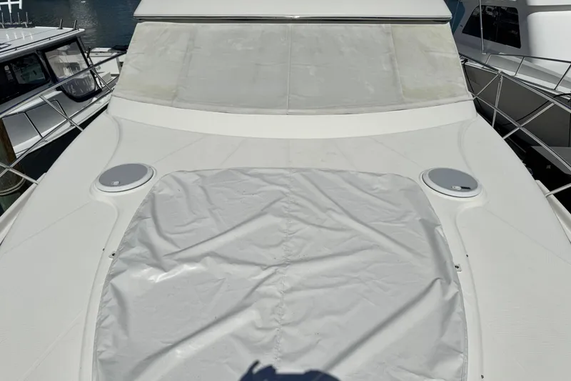 Slide: The Image of 2009 Ovation 52 yacht deck with protective cover, docked at marina. - 21