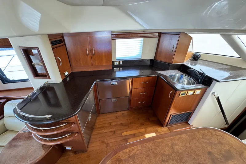 Slide: The Image of Luxurious 2009 Ovation 52 yacht kitchen with wood cabinetry and modern appliances. - 24