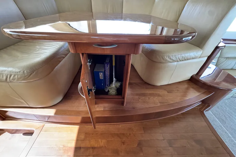 Slide: The Image of Luxurious 2009 Ovation 52 yacht interior with wooden table and leather seating. - 25