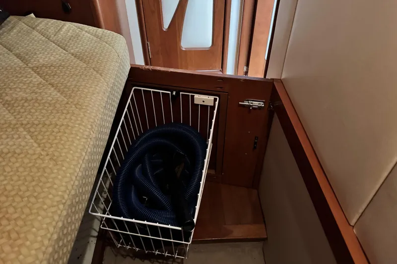 Slide: The Image of Storage compartment with coiled hose in 2009 Ovation 52 yacht interior. - 34