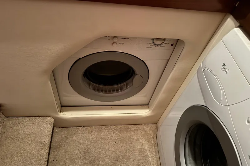 Slide: The Image of Compact laundry area with built-in washer and dryer on an Ovation 52 yacht, 2009 model. - 36