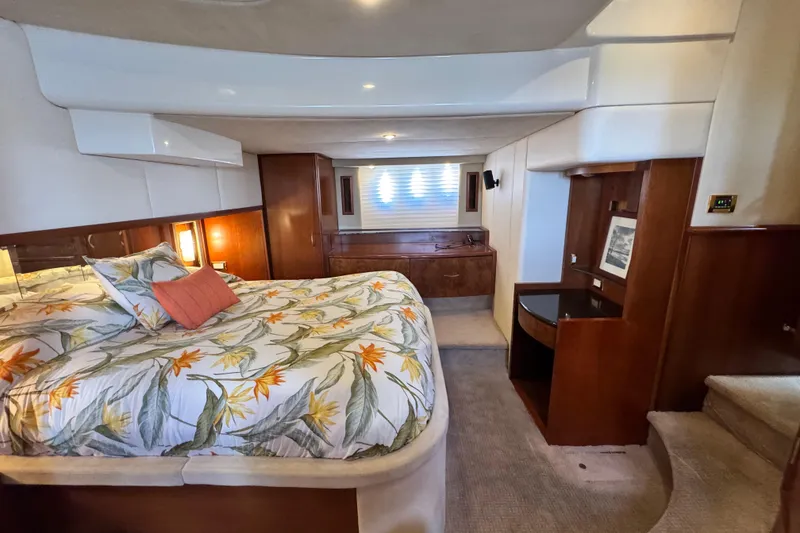 Slide: The Image of Luxurious 2009 Ovation 52 yacht bedroom with floral bedding and elegant wood accents. - 42
