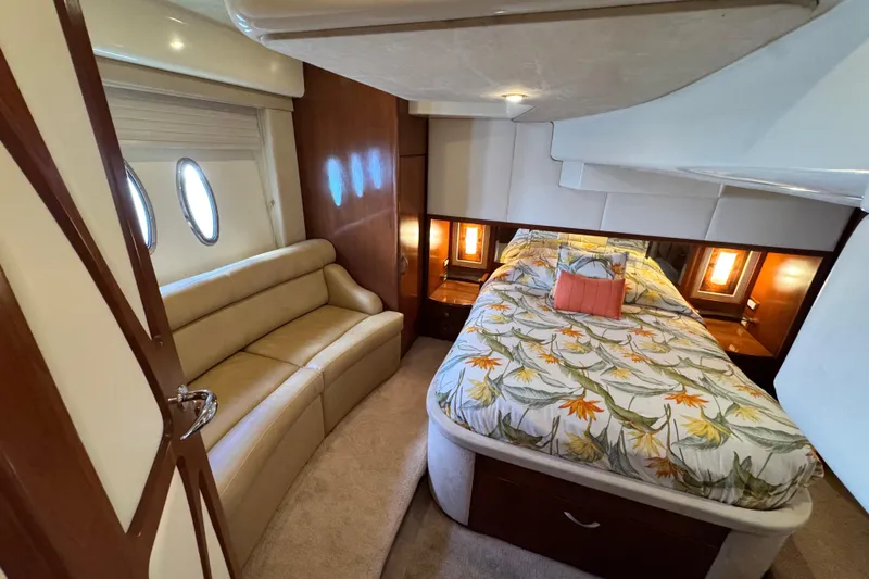 Slide: The Image of Luxurious 2009 Ovation 52 yacht cabin with floral bedding and elegant seating. - 43
