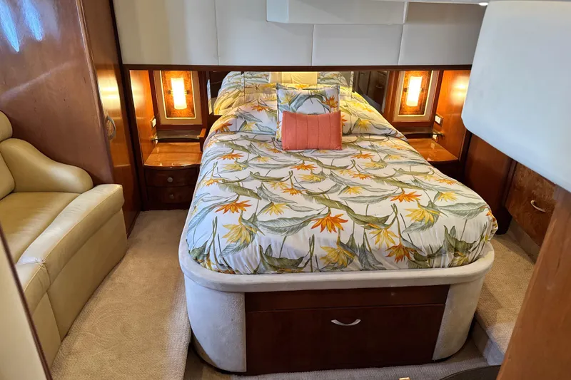 Slide: The Image of Luxurious 2009 Ovation 52 yacht bedroom with floral bedding and elegant wood accents. - 44