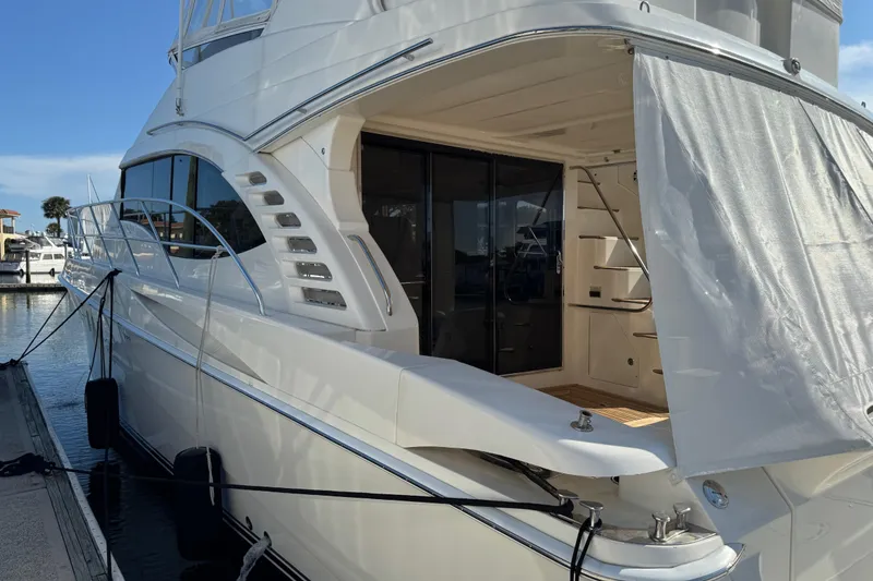 Slide: The Image of Luxury 2009 Ovation 52 yacht docked at marina, featuring sleek design and spacious deck. - 5