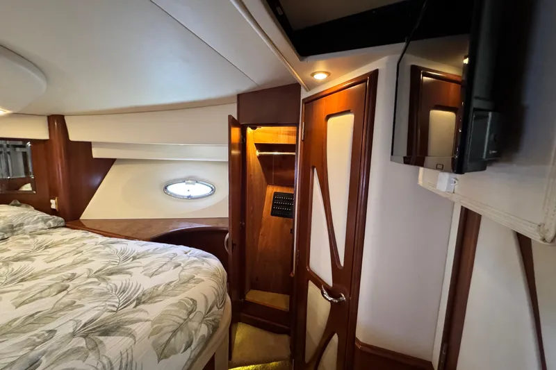 Slide: The Image of Luxurious 2009 Ovation 52 yacht interior with elegant wood finishes and cozy bedding. - 52