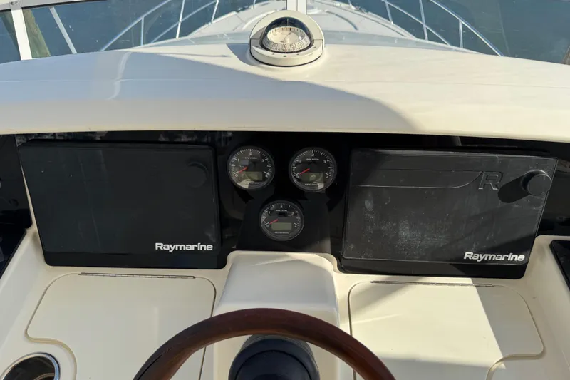 Slide: The Image of Control panel of a 2009 Ovation 52 yacht with Raymarine displays and gauges. - 6