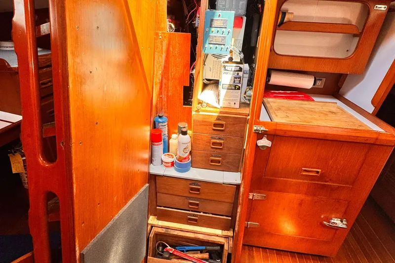 Slide: The Image of Interior of 1982 Kelly Peterson 46 sailboat with wooden cabinetry and storage compartments. - 18