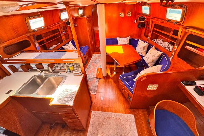 Slide: The Image of Interior of 1982 Kelly Peterson 46 yacht with wooden finish and cozy seating area. - 2