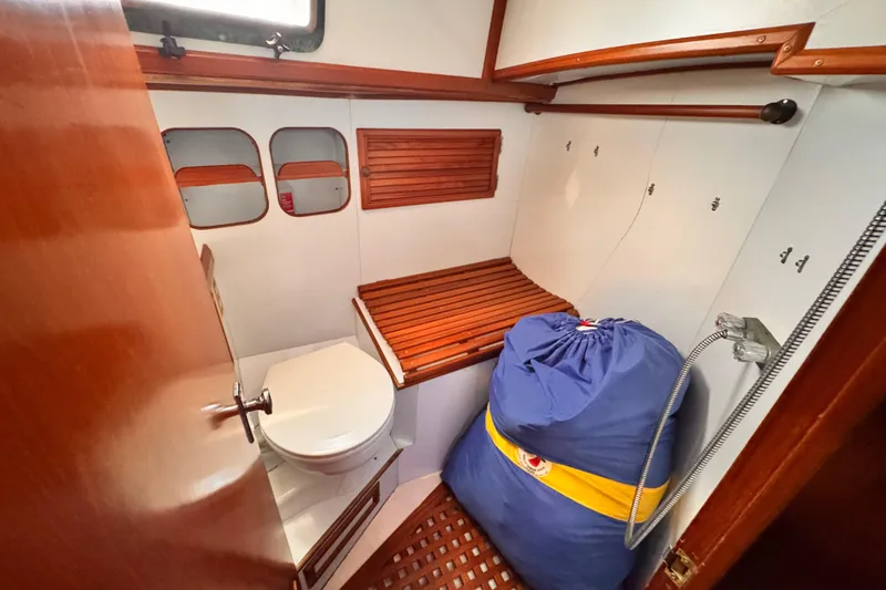 Slide: The Image of 1982 Kelly Peterson 46 yacht bathroom with wooden accents and compact design. - 25