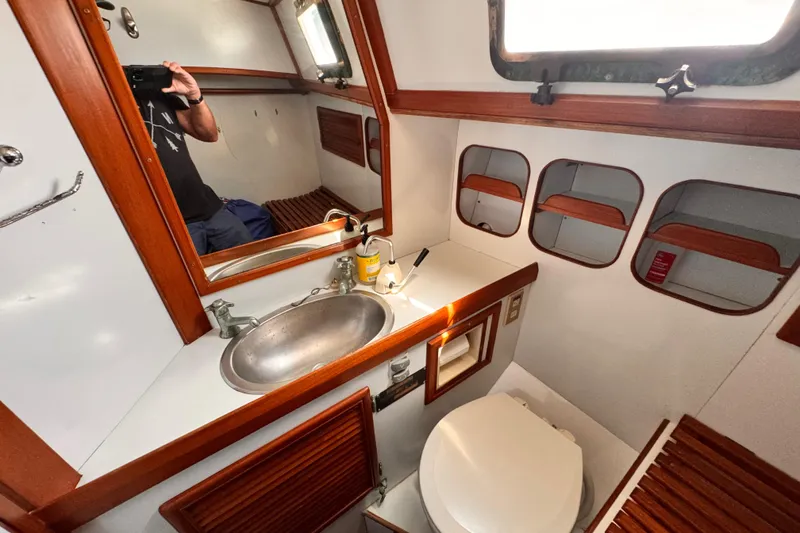 Slide: The Image of Interior of 1982 Kelly Peterson 46 yacht bathroom with sink, mirror, and toilet. - 26