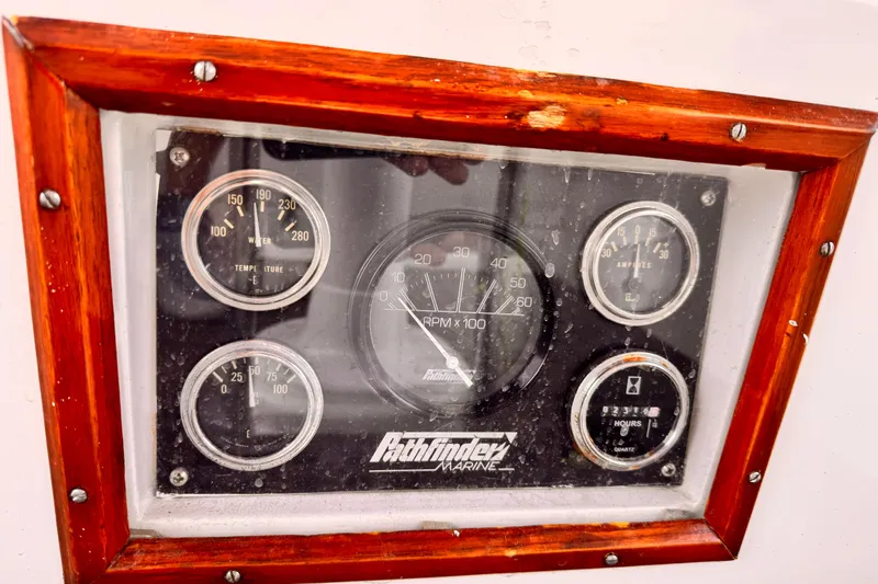 Slide: The Image of Instrument panel of a 1982 Kelly Peterson 46 sailboat with wooden frame. - 34