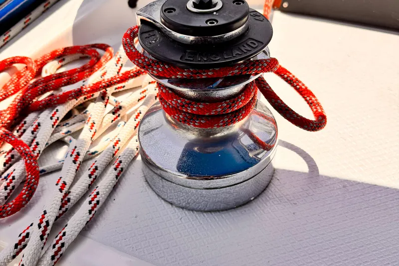 Slide: The Image of Winch with red and white ropes on 1982 Kelly Peterson 46 sailboat deck. - 35