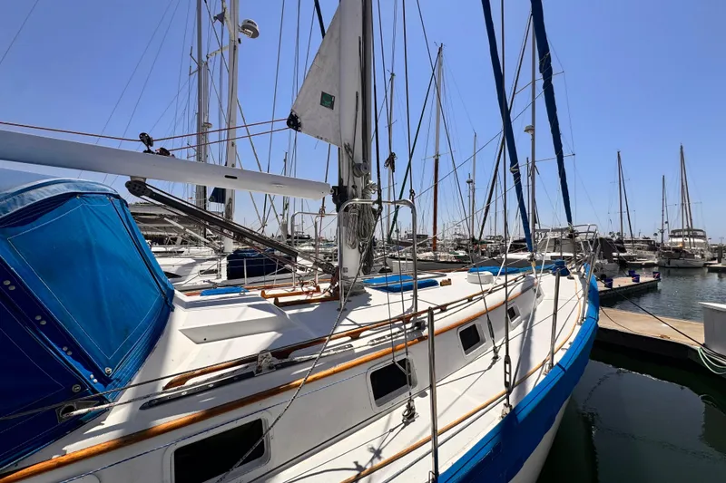 Slide: The Image of 1982 Kelly Peterson 46 sailboat docked in marina under clear blue sky. - 41