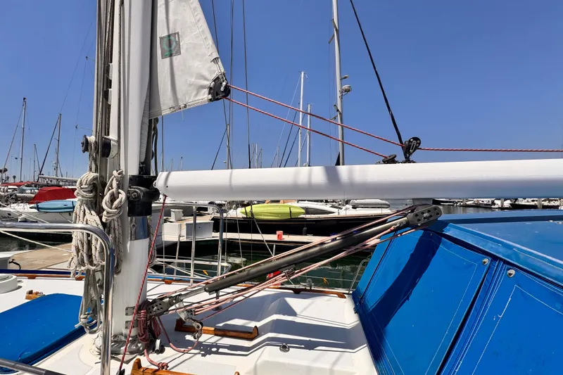 Slide: The Image of Sailboat deck view, Kelly Peterson 46, 1982 model, docked in marina under clear blue sky. - 42