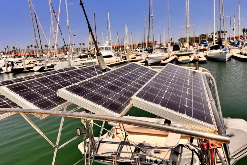 Slide: The Image of Solar panels on a 1982 Kelly Peterson 46 sailboat in a marina. - 44