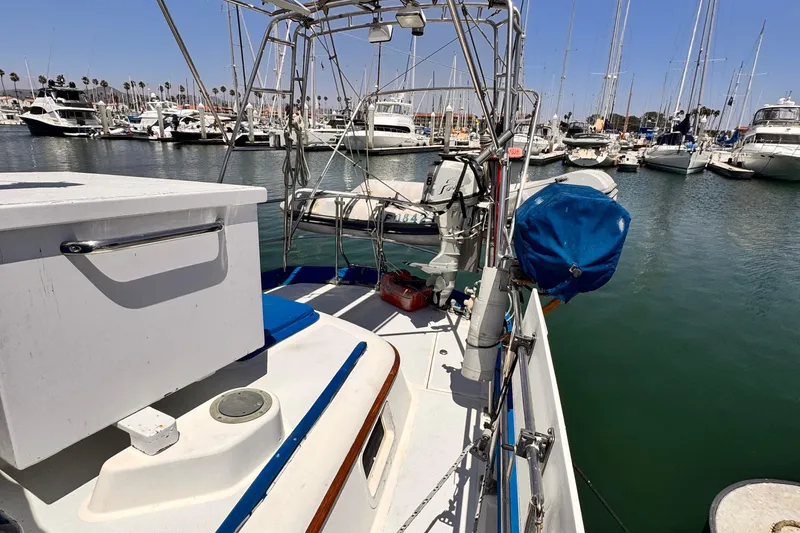 Slide: The Image of 1982 Kelly Peterson 46 sailboat docked in a marina, surrounded by other boats. - 45