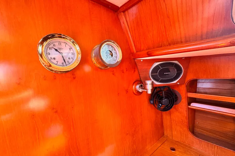 Slide: The Image of Interior of 1982 Kelly Peterson 46 yacht with clock, barometer, and speaker on wooden panel. - 7