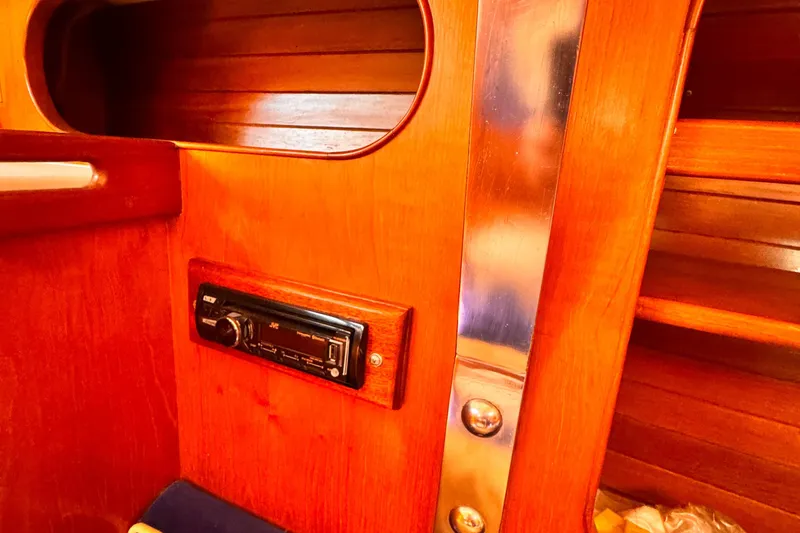Slide: The Image of Interior of 1982 Kelly Peterson 46 yacht with wooden paneling and JVC stereo system. - 9