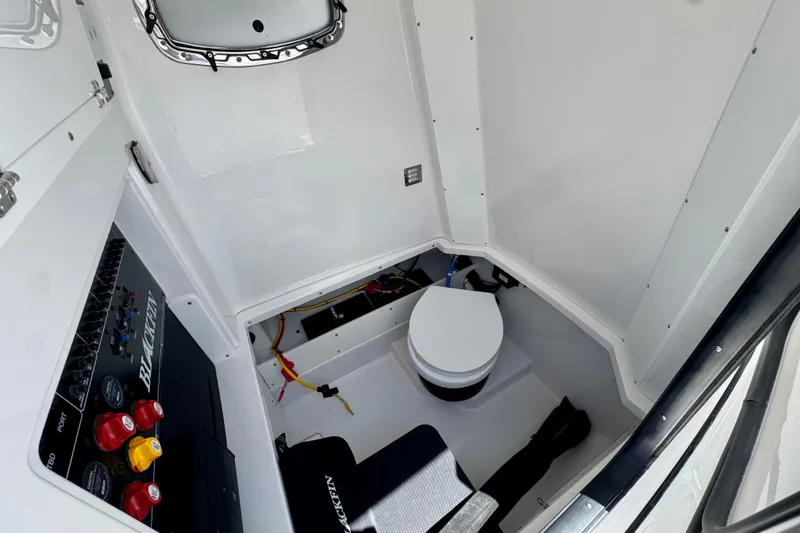 Slide: The Image of Interior of 2026 Blackfin 272 CC boat featuring a compact marine toilet. - 28