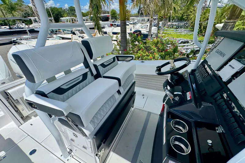 Slide: The Image of 2026 Blackfin 272 CC boat interior with white seating and modern helm controls. - 29