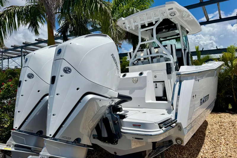 Slide: The Image of 2026 Blackfin 272 CC boat with dual Mercury engines, set against a tropical backdrop. - 3