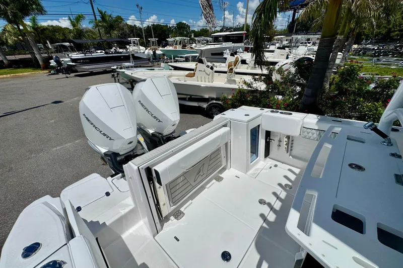 Slide: The Image of 2026 Blackfin 272 CC boat with dual Mercury engines in a marina setting. - 32