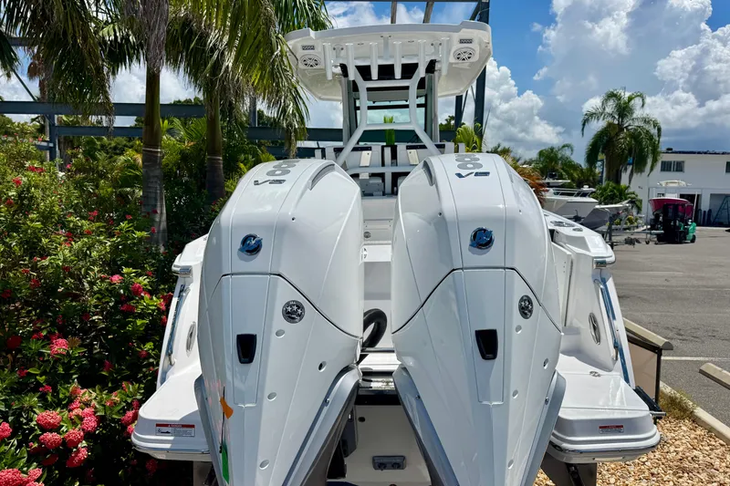 Slide: The Image of 2026 Blackfin 272 CC boat with dual V8 engines, surrounded by tropical plants. - 4