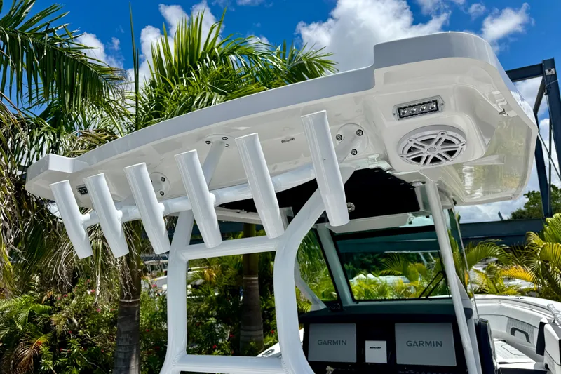 Slide: The Image of 2026 Blackfin 272 CC boat with rod holders and speaker, set against a tropical backdrop. - 9