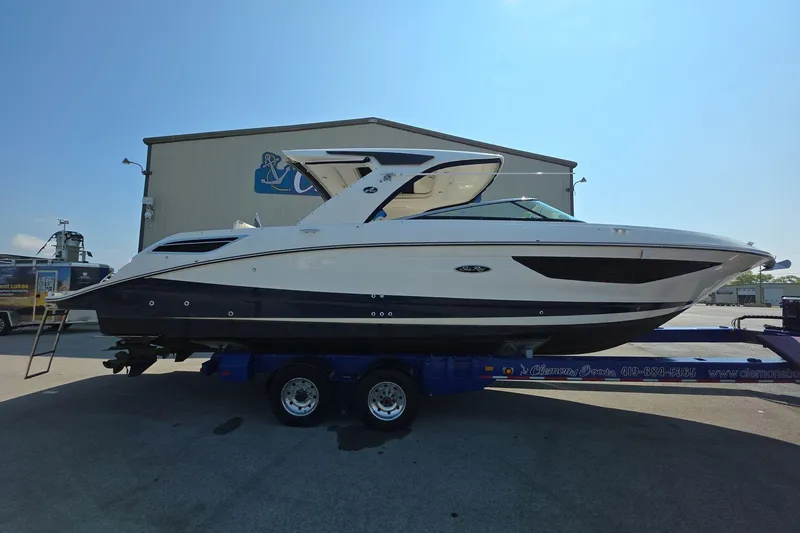 The Image of 2020 Sea Ray SLX 350 boat on trailer, parked outdoors near a building. - 0