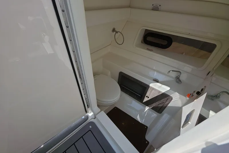 Slide: The Image of 2020 Sea Ray SLX 350 boat interior bathroom with toilet and sink. - 10