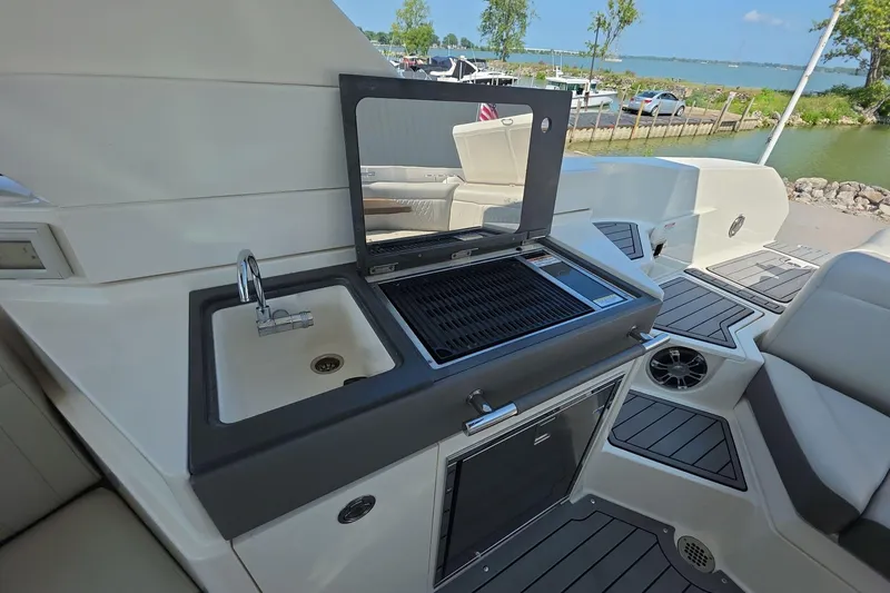 Slide: The Image of 2020 Sea Ray SLX 350 boat with outdoor sink and grill on deck. - 11