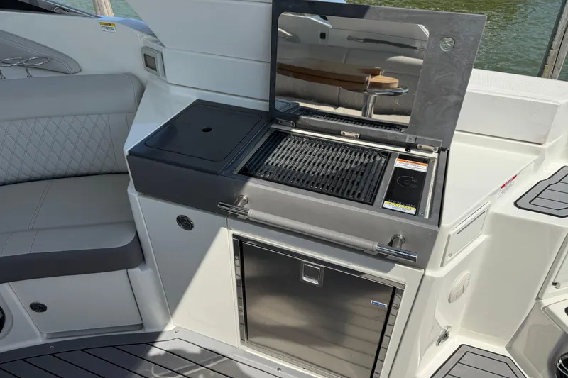Slide: The Image of 2020 Sea Ray SLX 350 boat with onboard grill and seating area. - 17