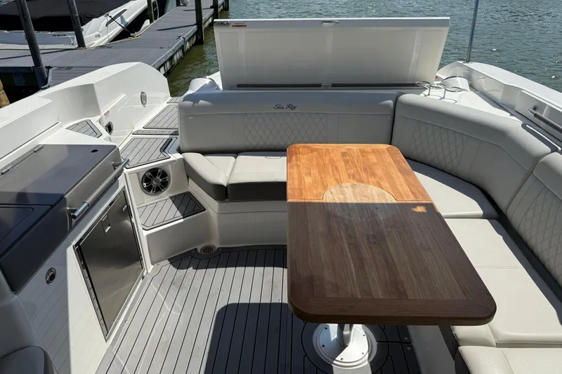 Slide: The Image of Luxurious 2020 Sea Ray SLX 350 boat interior with elegant seating and wooden table. - 20