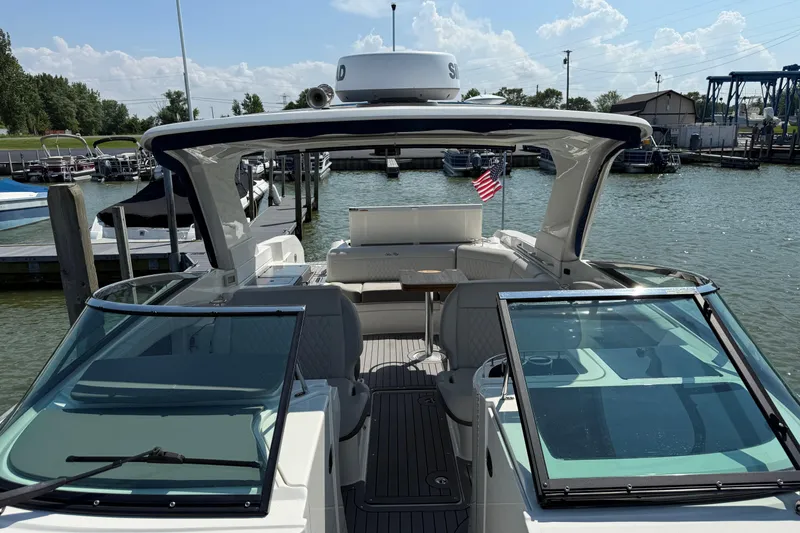 Slide: The Image of 2020 Sea Ray SLX 350 boat docked, featuring spacious seating and sleek design. - 22