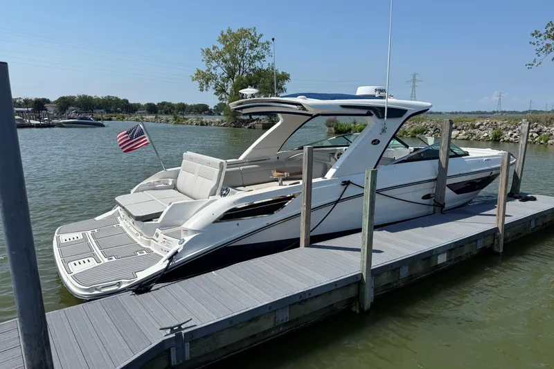 Slide: The Image of 2020 Sea Ray SLX 350 boat docked, featuring sleek design and American flag. - 27