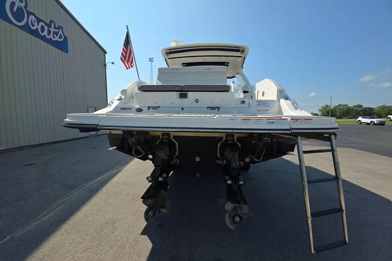 Slide: The Image of 2020 Sea Ray SLX 350 boat rear view with ladder, parked near a building. - 5
