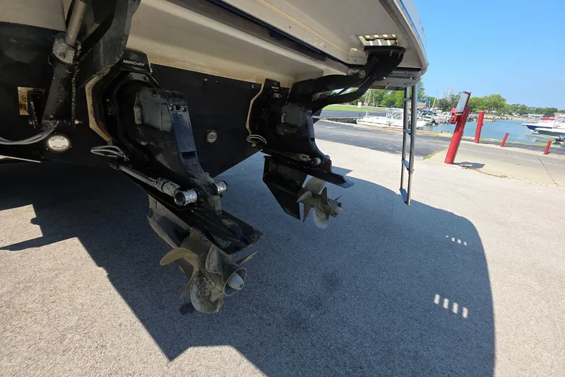 Slide: The Image of 2020 Sea Ray SLX 350 boat with dual outboard motors at a marina. - 6