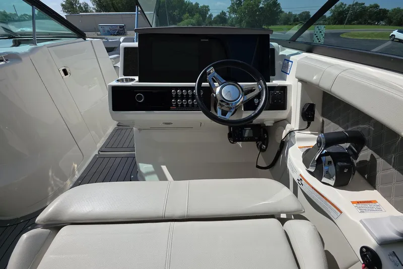 Slide: The Image of Interior view of 2020 Sea Ray SLX 350 boat cockpit with steering wheel and controls. - 8
