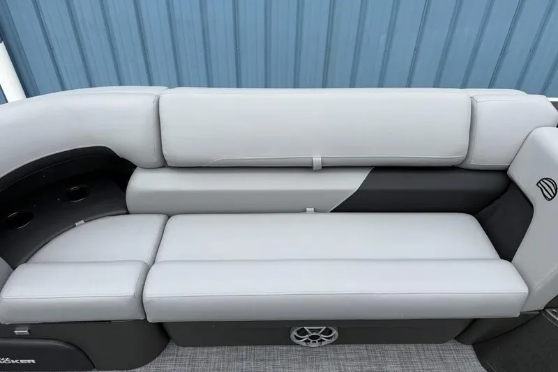 Slide: The Image of 2026 Sun Tracker Party Barge 22 DLX, featuring sleek gray seating and cup holders. - 10